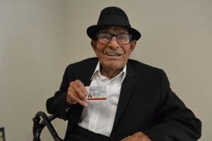 Alfonso Gonzales receives a new student ID card.