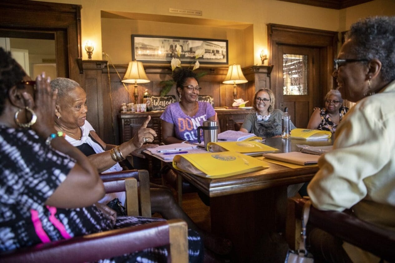 Women talk about their caregiving experiences at a support group meeting last year