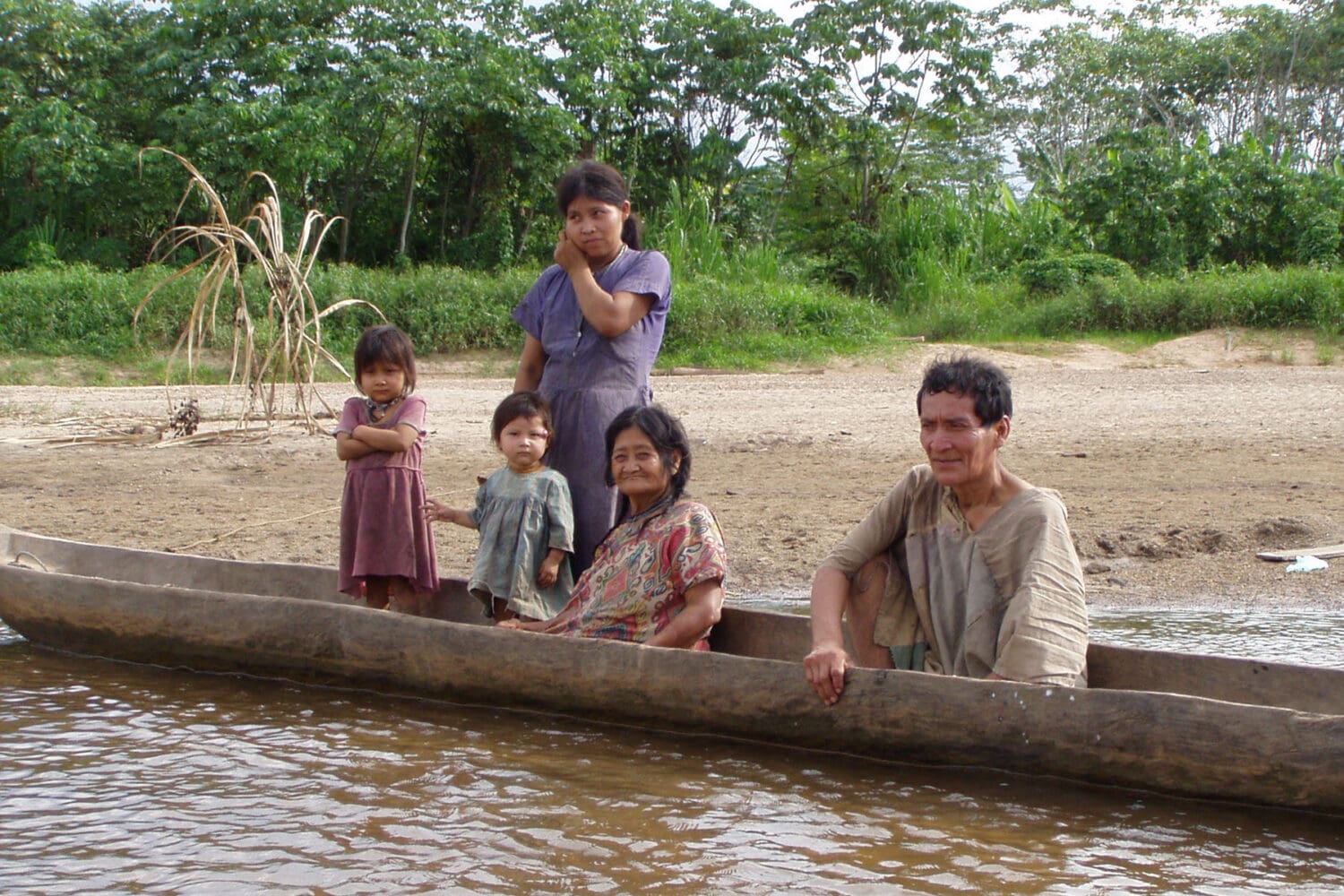 A Tsimane family travels upstream in the local river