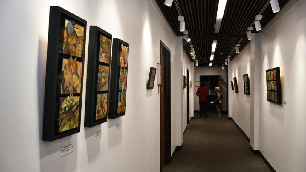 A hallway adorned with paintings on the wall