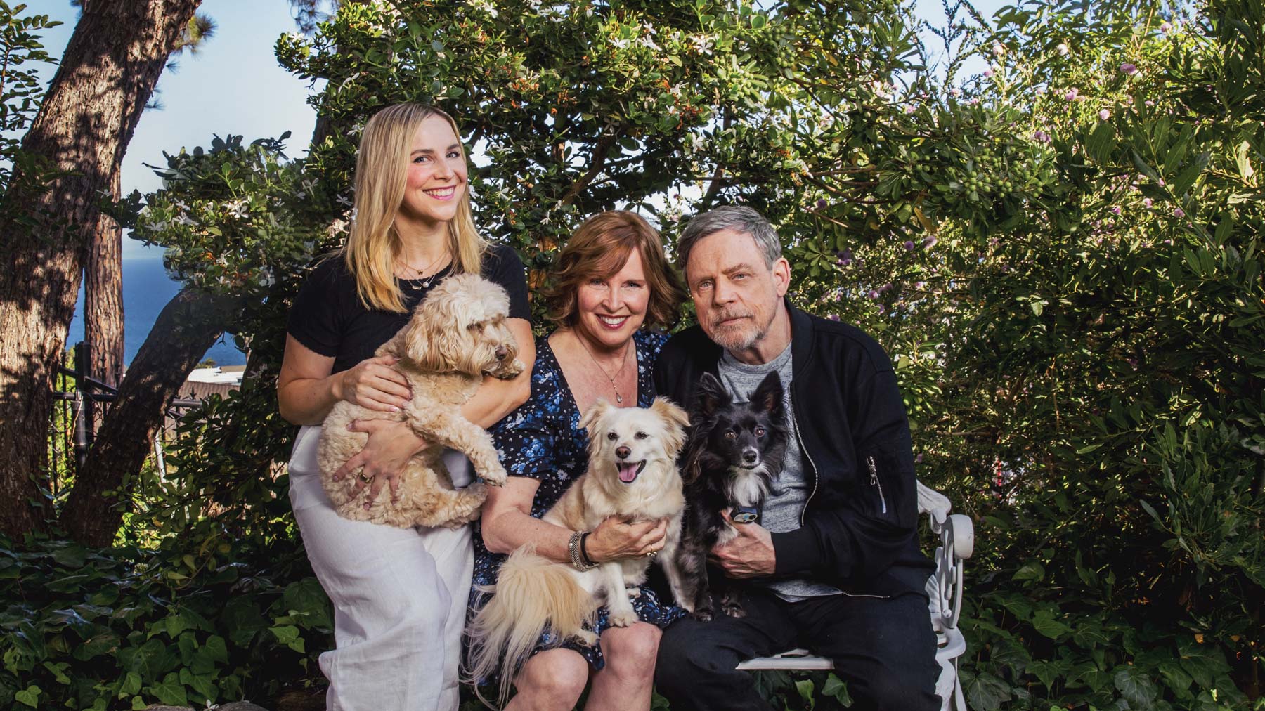 Magazine cover of Vitality with Marilou and Mark Hamill sitting side by side smiling with their daughter and dogs