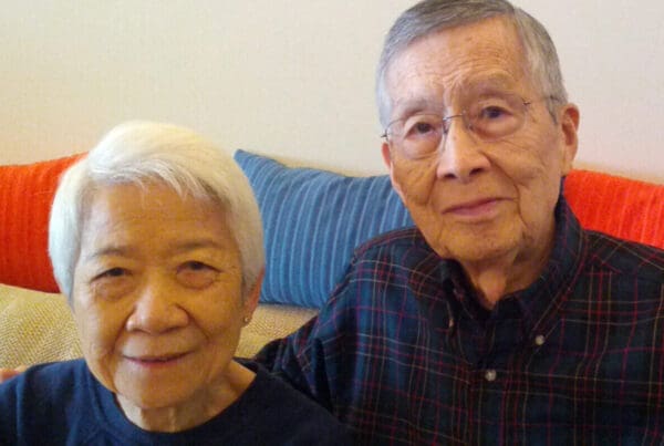 Portrait of Wm and Anita Jeung seated on a couch