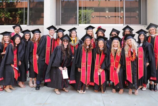 Dozens of students in commencement robes and sashes at the USC Leonard Davis School of Gerontology Commencement 2024