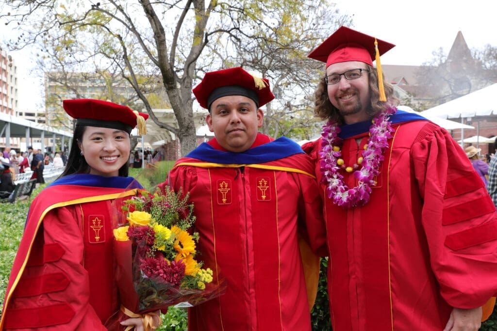 Three students in PhD commencement robes at the USC Leonard Davis School of Gerontology Commencement 2024