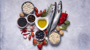 Variety of Mediterranean healthy foods based on legumes, fish, vegetables, fruits and grains in the shape of a heart